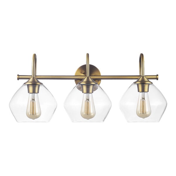 A Globe 3-light brass vanity light fixture with clear glass shades.