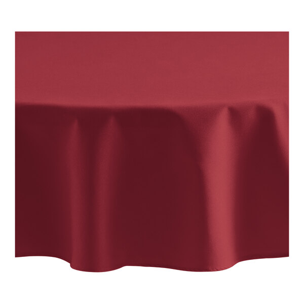 An Oxford burgundy round tablecloth on a table.