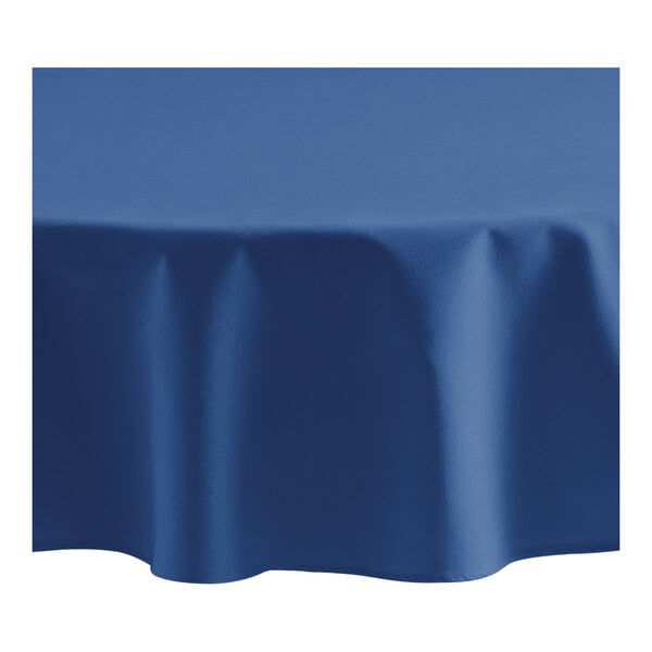 An Oxford blue round tablecloth on a white table.