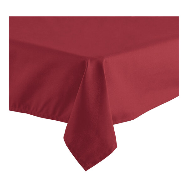 A burgundy square table cover with a folded edge on a table.