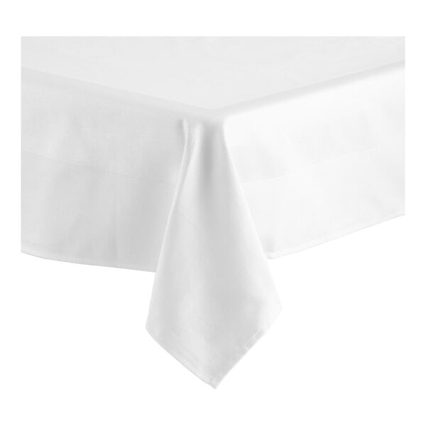 A close-up of a white Oxford square tablecloth with a folded edge and a satin band.