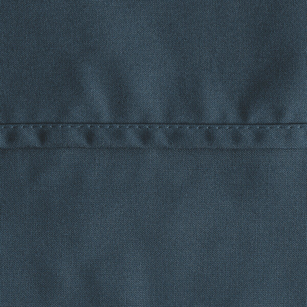 A close up of a navy blue rectangular cloth table cover with stitching.