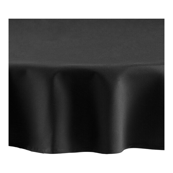 A black Oxford round tablecloth with a hemmed edge on a table.