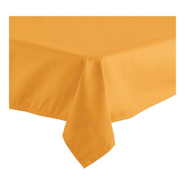 A gold rectangular tablecloth on a table.