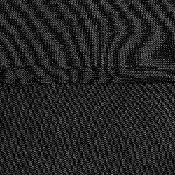A close up of a black Oxford cloth round table cover with a hemmed edge.