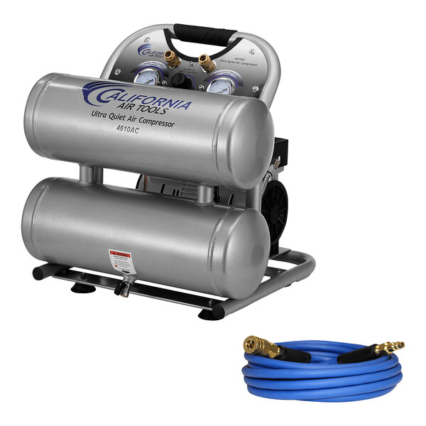 A silver California Air Tools air compressor with twin tanks and gauges, next to a hose.