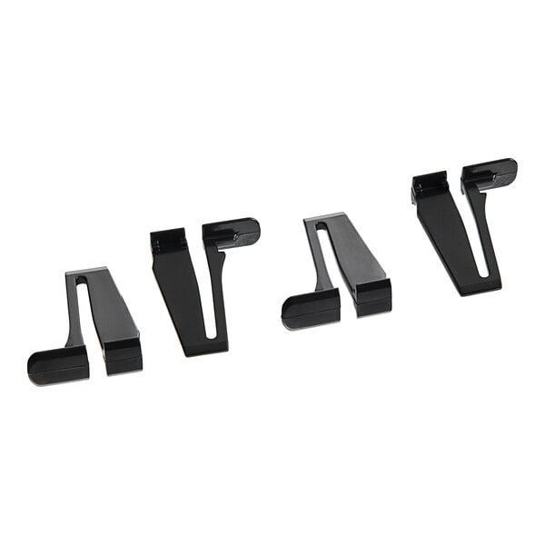 A close up of a black Tork Xpressnap Signature in-counter napkin dispenser with three plastic clips.