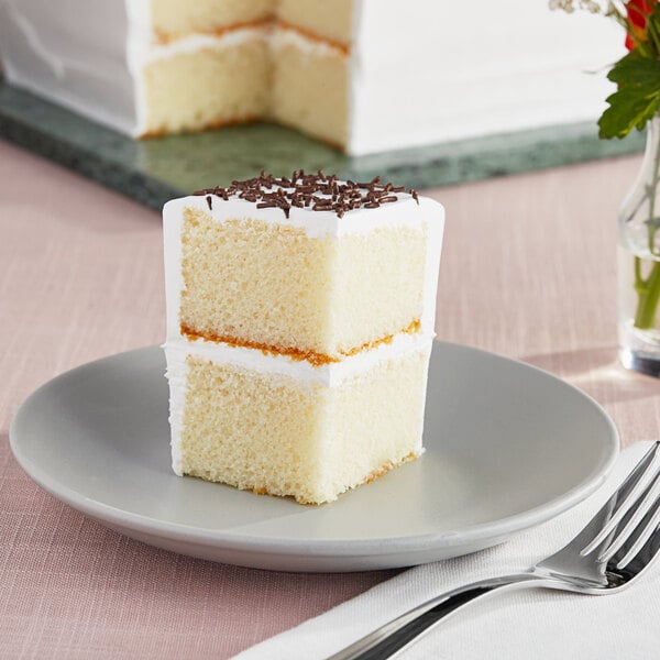 A slice of Rich's Allen white cake on a plate with a fork.