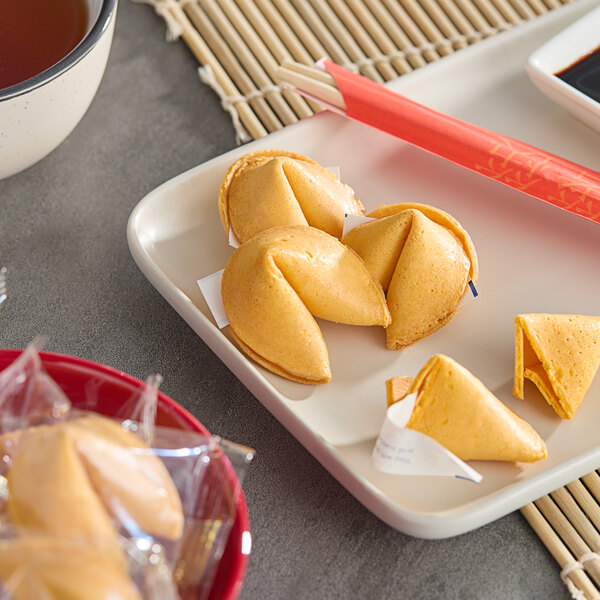 A plate of La Choy fortune cookies with chopsticks.