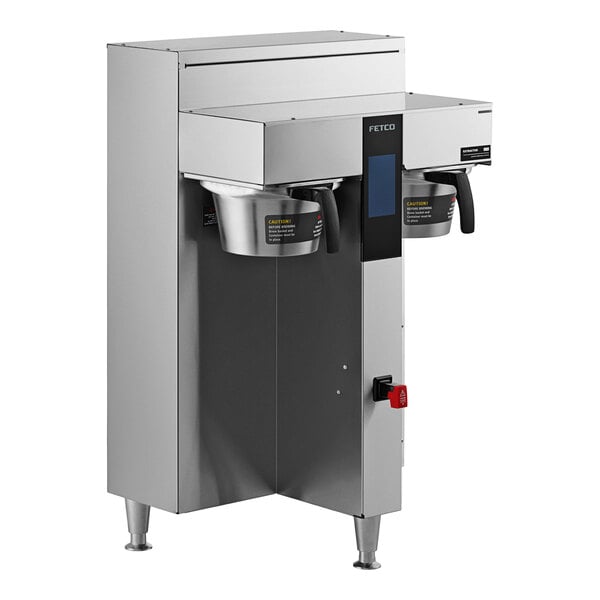 A Fetco commercial coffee brewer with a stainless steel base.