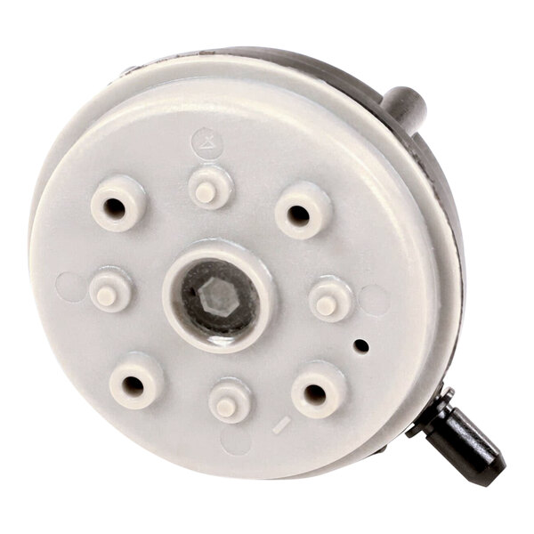 A white circular object with many holes.
