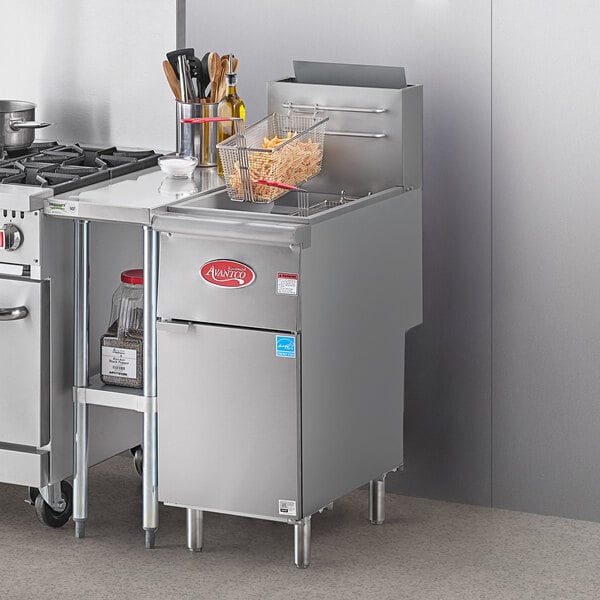 A commercial kitchen with a stainless steel Avantco floor fryer and a stove.