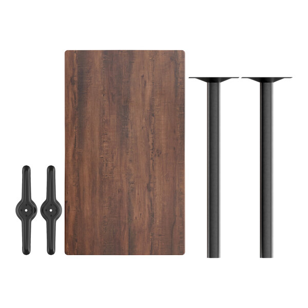 A Lancaster Table & Seating rectangular walnut bar height table with black metal legs.