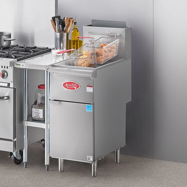 An Avantco liquid propane floor fryer in a commercial kitchen with baskets of food.