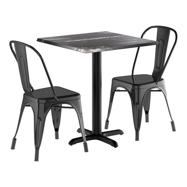 A black table with two chairs.