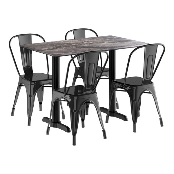 A Lancaster Table & Seating rectangular black metal table with four black chairs.