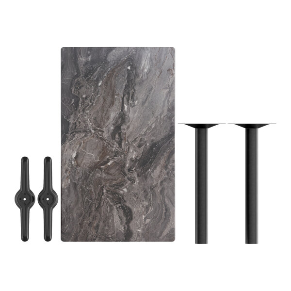 A Lancaster Table with a smooth marble top and black metal legs with four black metal chairs.