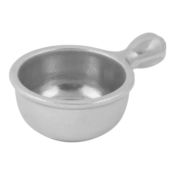 A silver metal Bon Chef soup bowl with a handle.