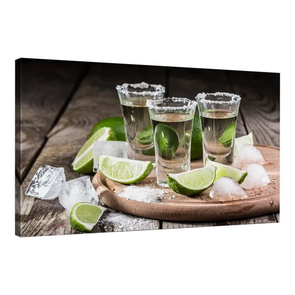 A group of shot glasses with limes and ice on a wooden tray.