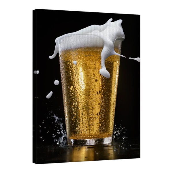 A 24" x 36" canvas wall art with a glass of beer with foam on top.