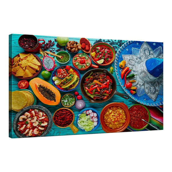 A colorful Mexican cuisine spread on a table with a blue background.