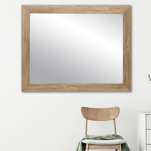 A BrandtWorks blonde barn wall finish mirror on a wall.