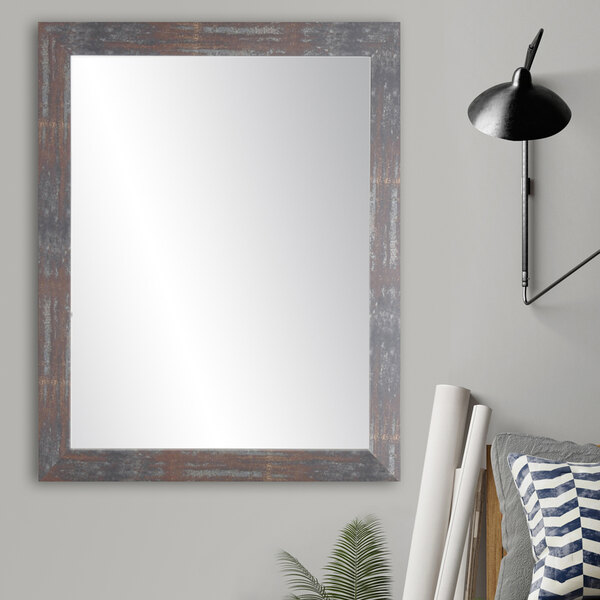 A BrandtWorks Lauralee modern rustic mirror with a wooden frame on a wall.