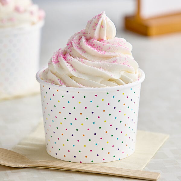 A Choice white paper food cup filled with frozen yogurt and pink sprinkles.