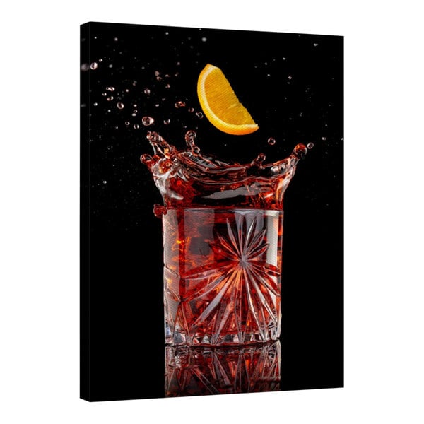 A glass of red liquid with a design on it and a slice of orange on the rim.