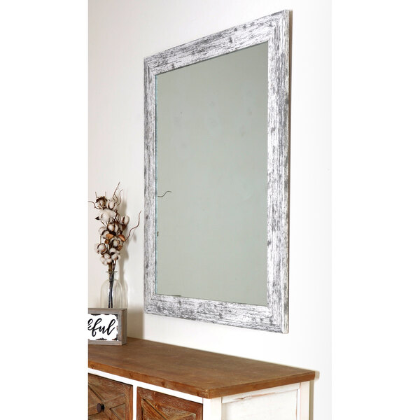 A BrandtWorks American Barn white mirror with a wooden frame on a wall.