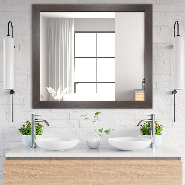 A BrandtWorks modern espresso finish mirror above a bathroom vanity with two sinks.