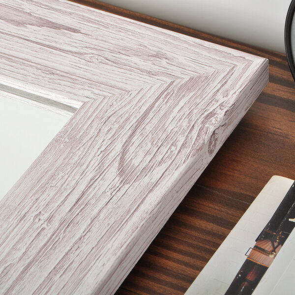 A close-up of a wood frame for a BrandtWorks Cream Farmhouse Grain Finish Mirror.