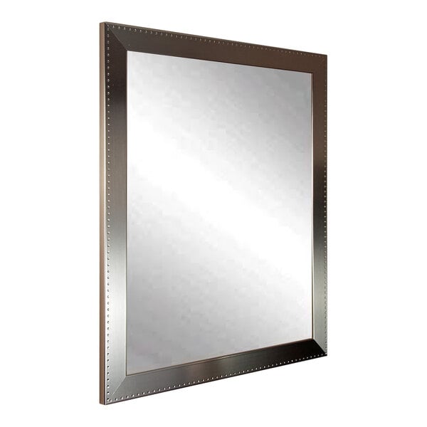 A BrandtWorks mirror with an embossed silver frame.