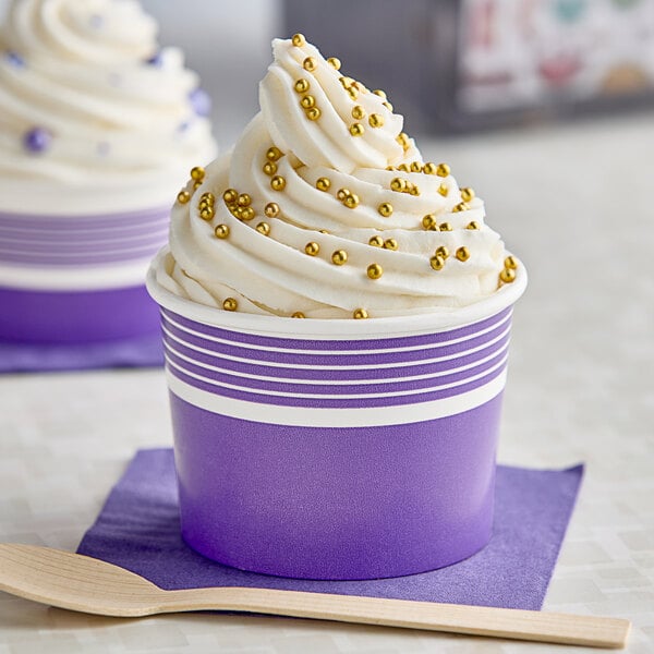 A purple Choice paper cup filled with ice cream and gold sprinkles.