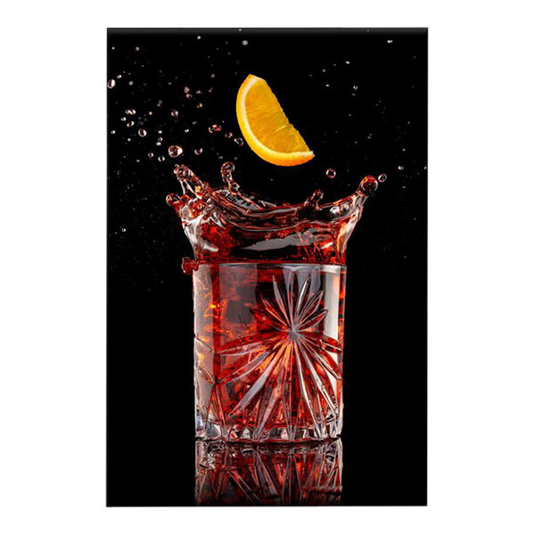 A white canvas with a splash of red liquid and a slice of orange.