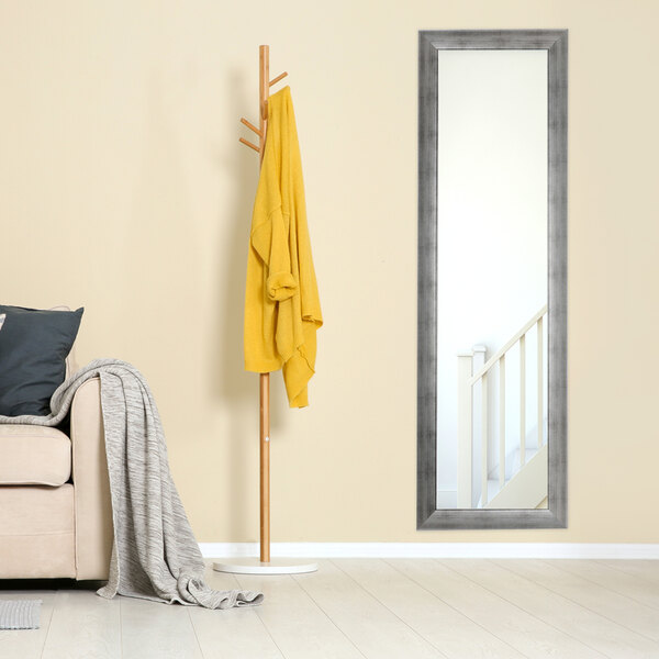 A BrandtWorks swirled vintage silver mirror next to a couch.
