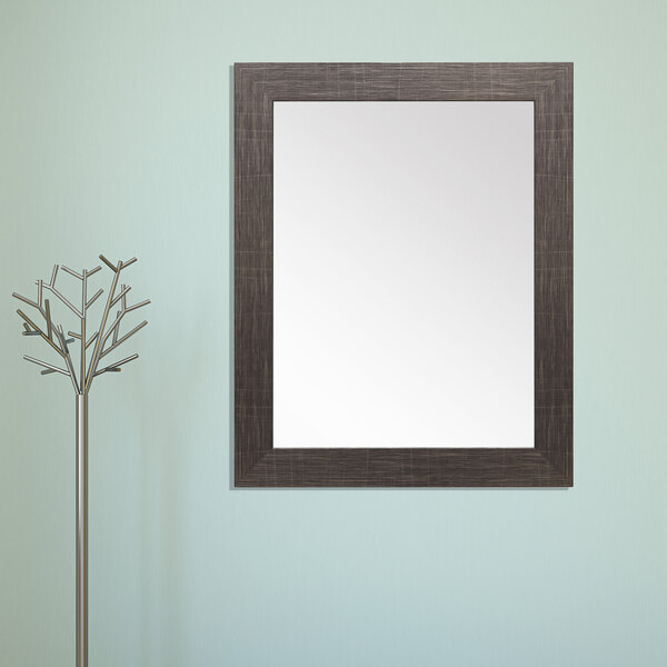 A BrandtWorks scratched black finish mirror on a wall.