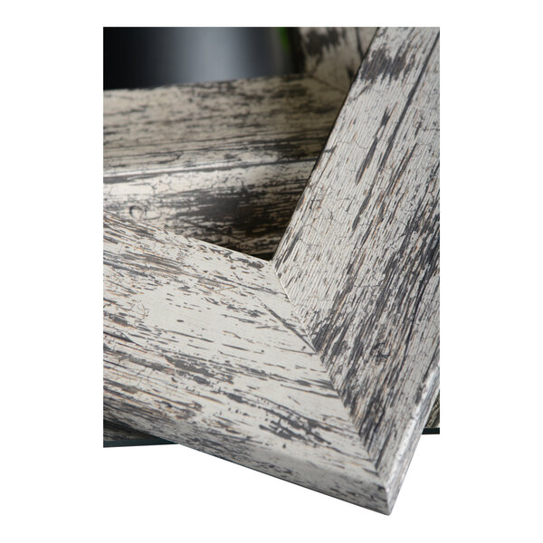 A close up of a wood frame with a white and gray paint.