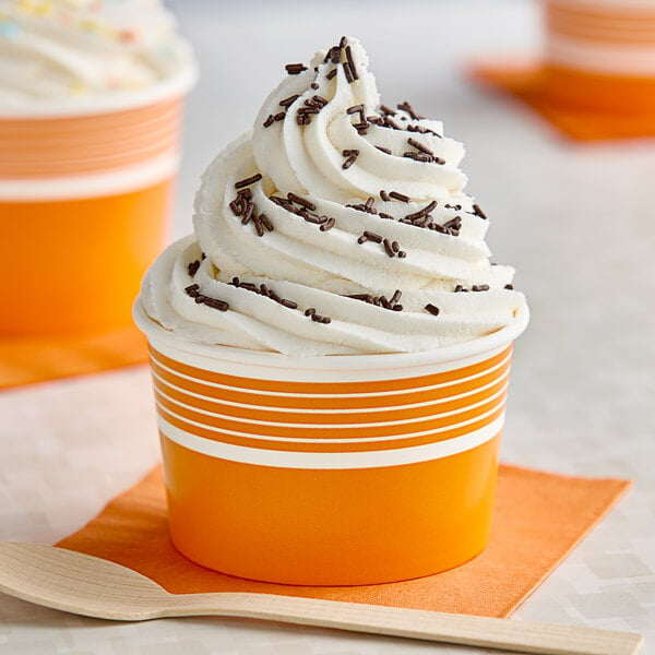 A close up of an orange and white striped Choice paper cup filled with ice cream.