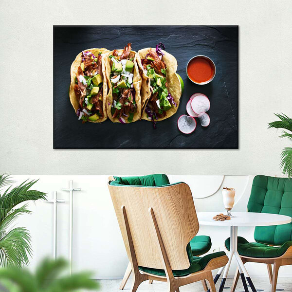 A white canvas wall art with a group of gourmet pork tacos.
