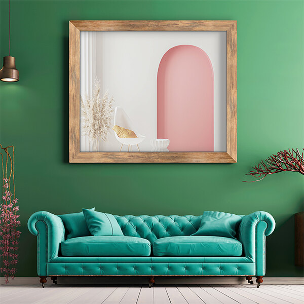 A BrandtWorks blonde barn wall mirror over a blue couch with pillows.