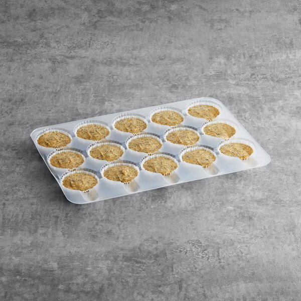 A tray of Brill pre-portioned lemon poppy seed muffin batter with six muffins on a counter.