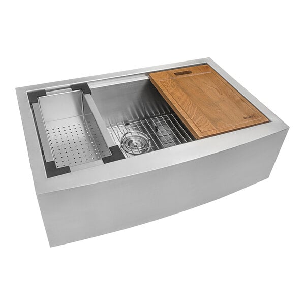 A stainless steel Ruvati Verona farmhouse sink with a wooden tray.