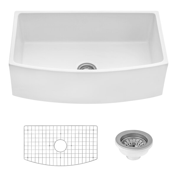 A white Ruvati farmhouse sink with a drain.