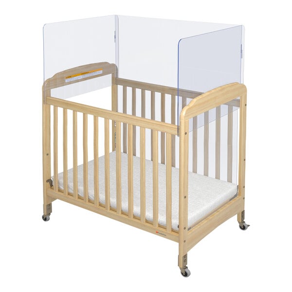 A wooden crib with a clear top.