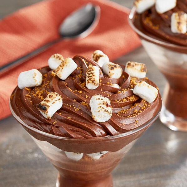 A cup of chocolate pudding with Kraft Mini Marshmallows and a spoon.