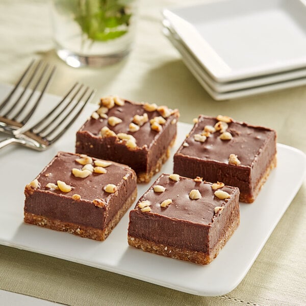 A Nats Rawline chocolate and hazelnut cake square with nuts on top.