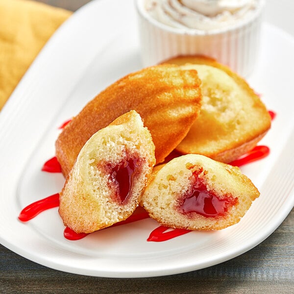 A white plate with St. Michel strawberry-filled madeleines.