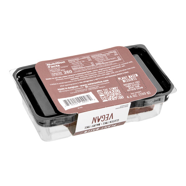 A plastic container with a Nats Rawline label containing two Caramel and Chocolate Raw Cake squares.