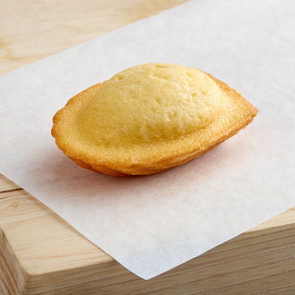 A St. Michel madeleine pastry sitting on a piece of paper.